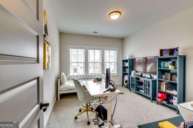 carpeted home office featuring visible vents and baseboards