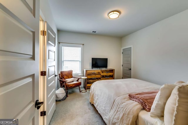 bedroom featuring visible vents and light colored carpet