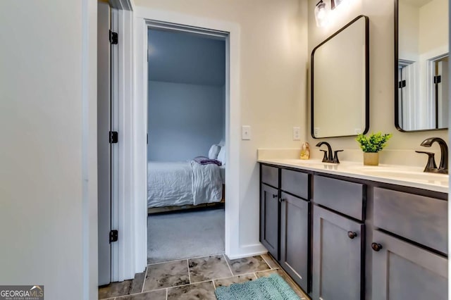 full bath featuring double vanity, ensuite bathroom, and a sink