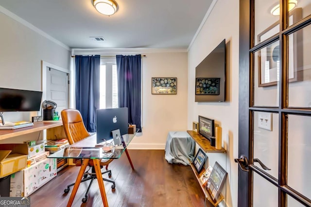 office area featuring visible vents, baseboards, wood finished floors, and crown molding