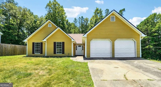 view of front of property with a garage, driveway, a front yard, and fence