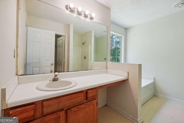 bathroom featuring a garden tub, a textured ceiling, a shower, baseboards, and vanity