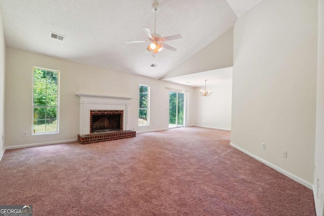 unfurnished living room with visible vents, ceiling fan with notable chandelier, carpet flooring, baseboards, and a brick fireplace