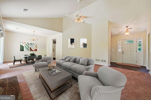 carpeted living area with visible vents, baseboards, high vaulted ceiling, and plenty of natural light