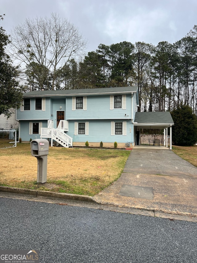 split foyer home with aphalt driveway, a front yard, and a carport