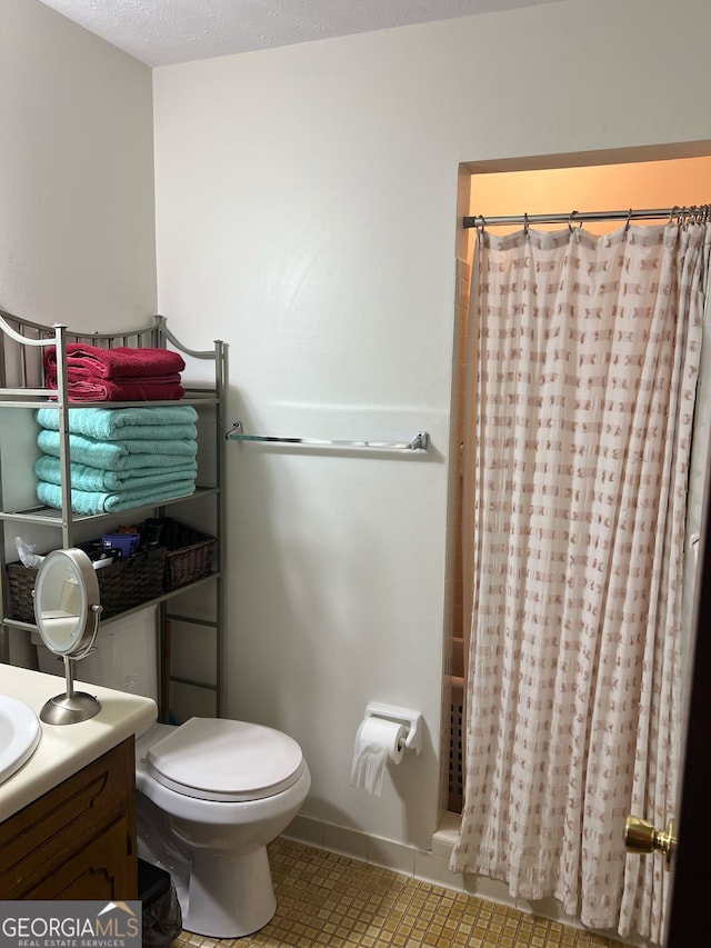 full bath with tile patterned floors, vanity, toilet, and shower / tub combo with curtain