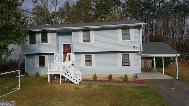 split foyer home with a carport, a front yard, and driveway