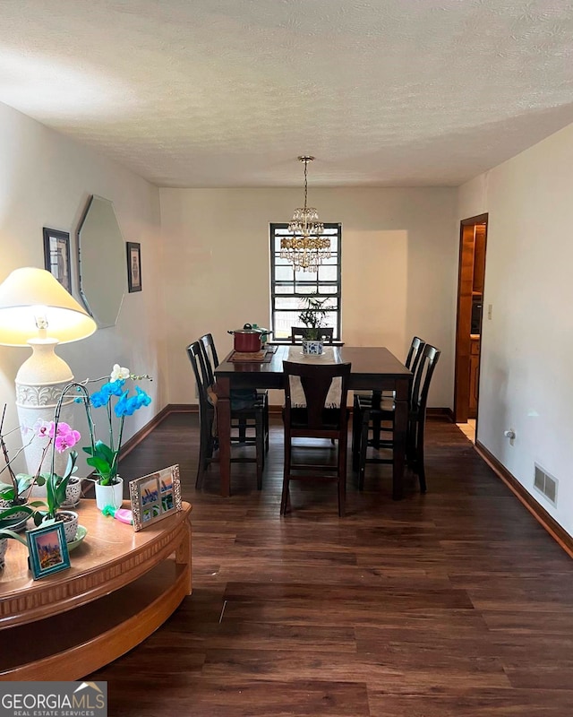 dining area with visible vents, a textured ceiling, baseboards, and dark wood-style flooring