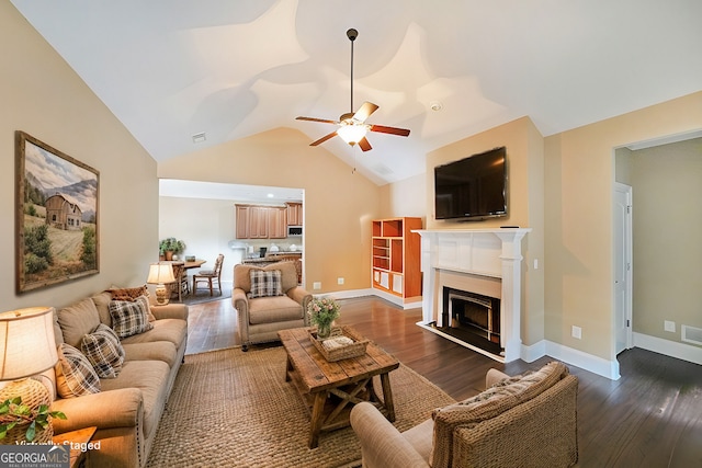 living area featuring a fireplace, ceiling fan, and wood finished floors