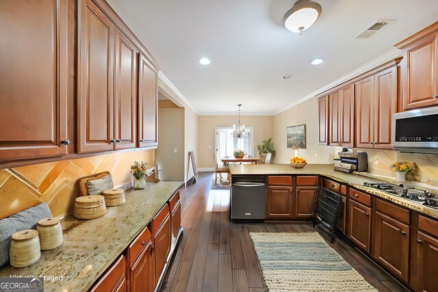 kitchen featuring dark wood-style floors, visible vents, a peninsula, ornamental molding, and stainless steel microwave