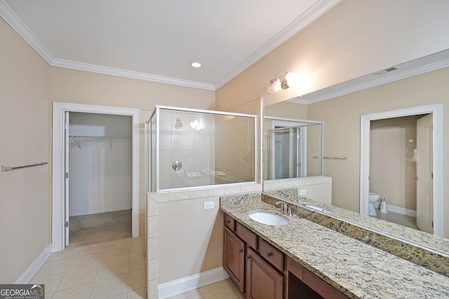 full bath with toilet, a stall shower, crown molding, tile patterned flooring, and vanity