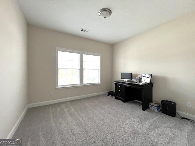 office space with visible vents, baseboards, and light colored carpet