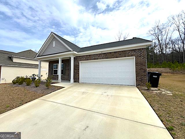 ranch-style house with brick siding, driveway, and a garage