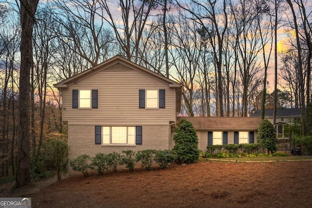 traditional-style home with brick siding