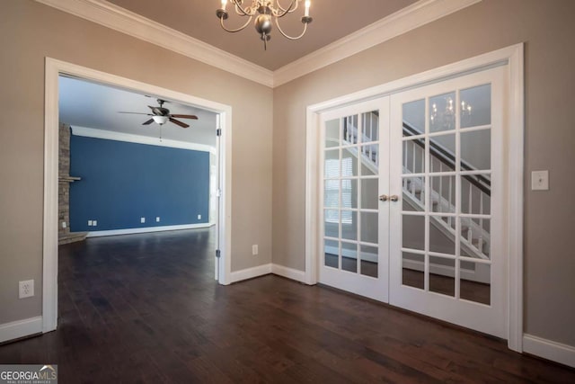 empty room featuring baseboards, ornamental molding, ceiling fan with notable chandelier, french doors, and wood finished floors