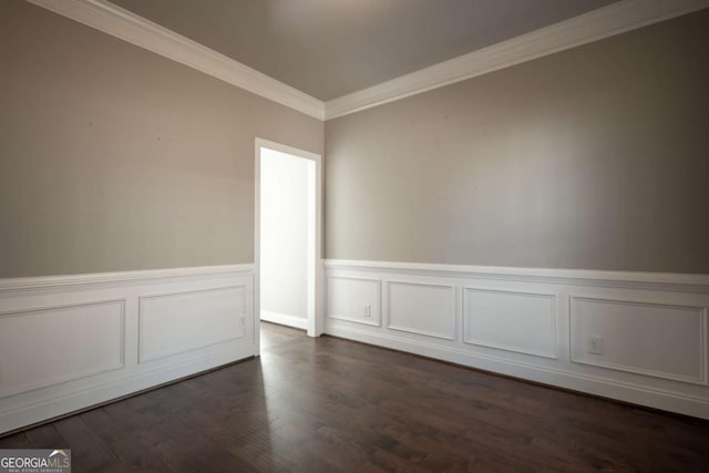 unfurnished room with crown molding, dark wood-style flooring, and wainscoting