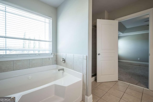 bathroom featuring tile patterned floors and a bath