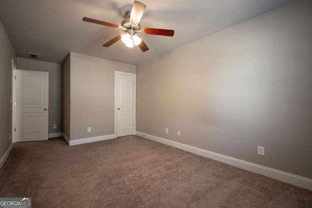 unfurnished bedroom featuring a ceiling fan, carpet flooring, visible vents, and baseboards