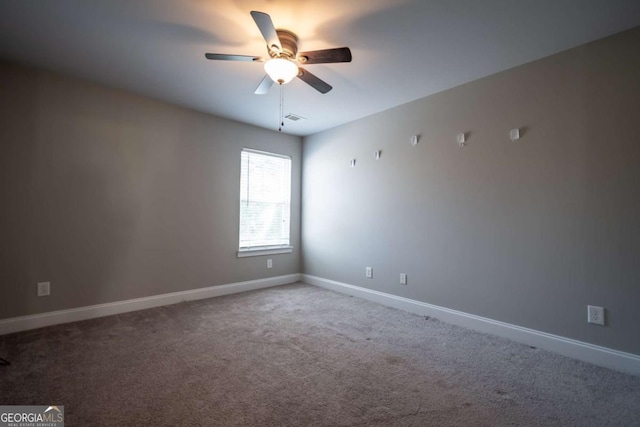 empty room featuring a ceiling fan, carpet flooring, baseboards, and visible vents