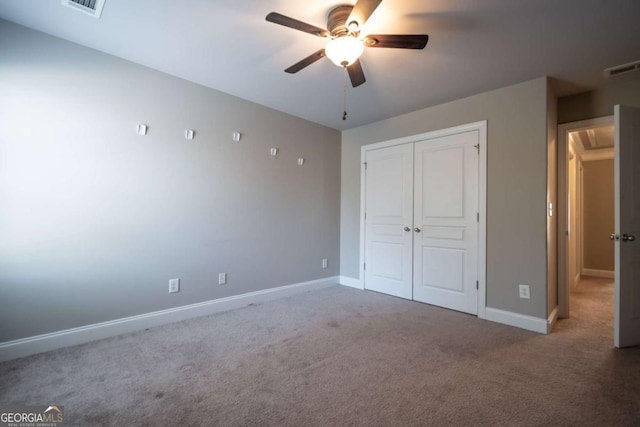 unfurnished bedroom with a closet, visible vents, baseboards, and carpet floors