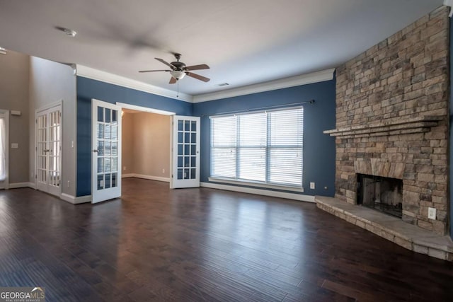 unfurnished living room featuring a stone fireplace, a ceiling fan, dark wood-style flooring, and ornamental molding