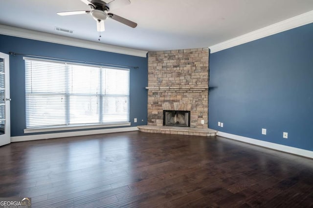 unfurnished living room featuring visible vents, a stone fireplace, wood finished floors, and ornamental molding