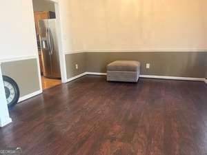 unfurnished room with baseboards and wood finished floors