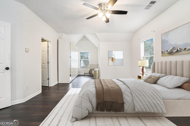 bedroom with visible vents, multiple windows, baseboards, and wood finished floors