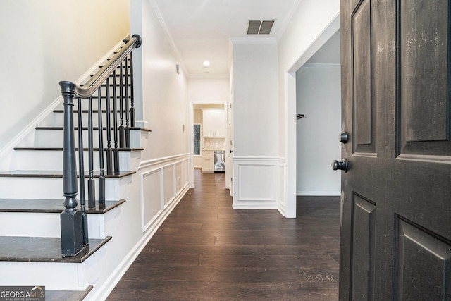 interior space featuring stairway, wood finished floors, visible vents, ornamental molding, and a decorative wall