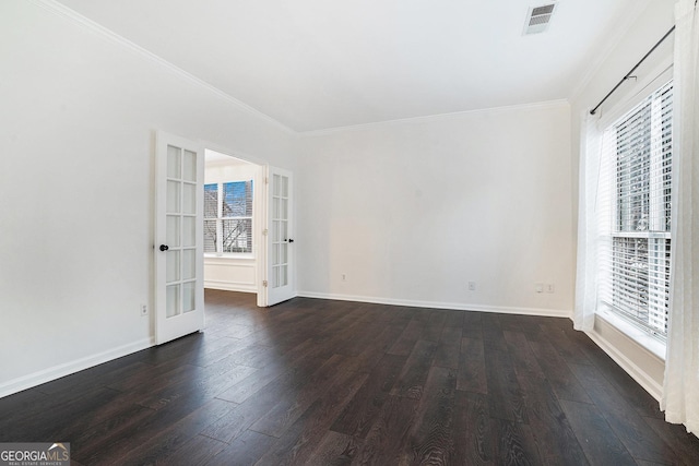 empty room with visible vents, plenty of natural light, french doors, and dark wood-type flooring