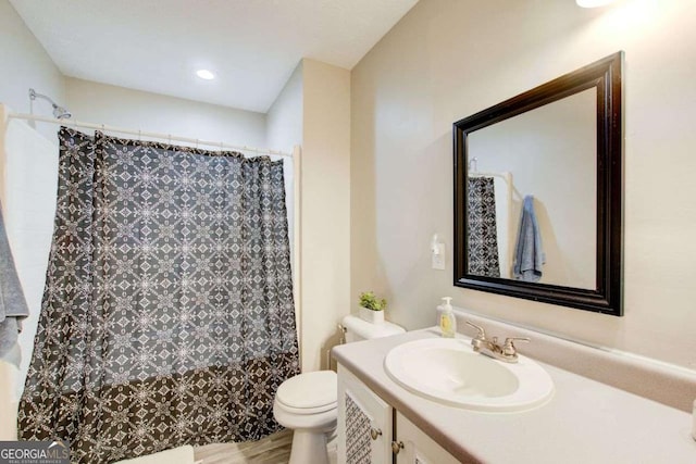 full bath featuring toilet, vanity, a shower with shower curtain, and wood finished floors