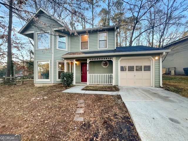 view of front of property with a porch, an attached garage, fence, and driveway