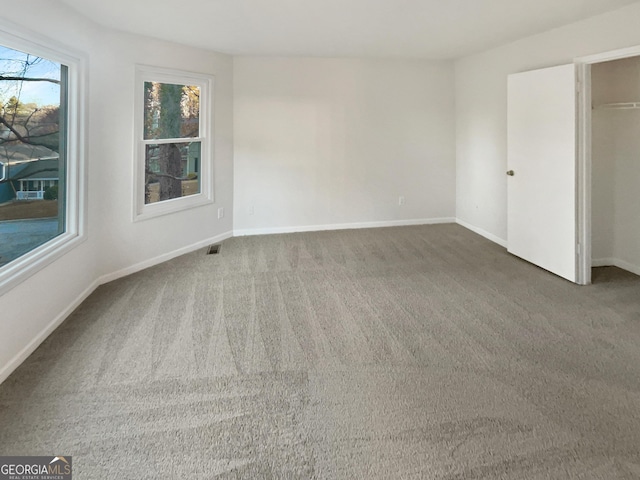 unfurnished bedroom featuring baseboards, visible vents, and carpet floors