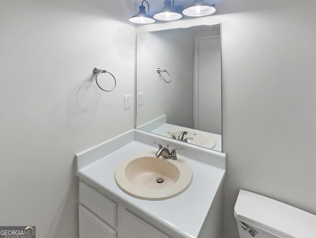 bathroom with toilet and vanity