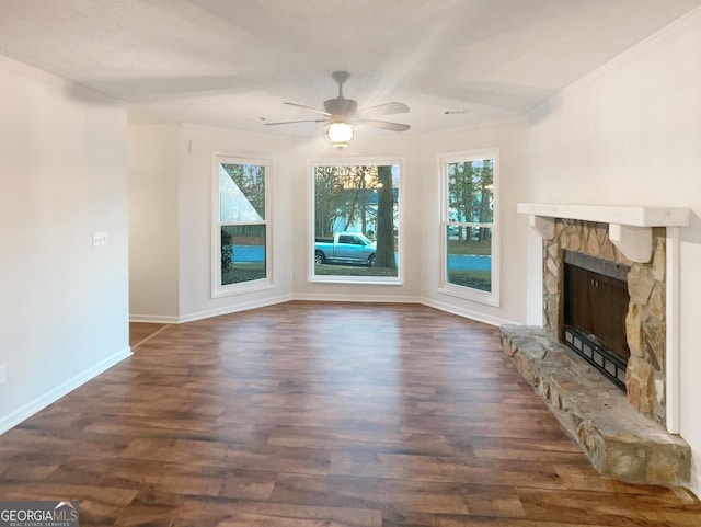 unfurnished living room featuring baseboards, dark wood-type flooring, ceiling fan, and a fireplace