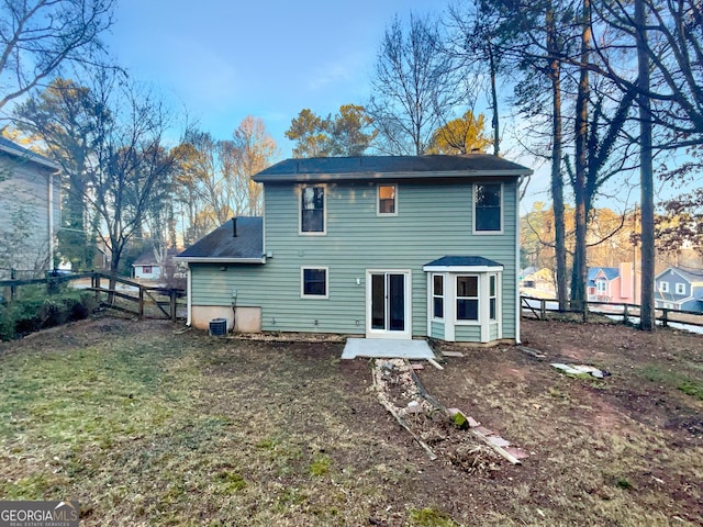 back of house featuring a yard and fence