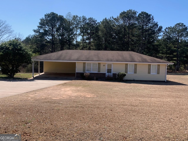 ranch-style home with a carport and concrete driveway