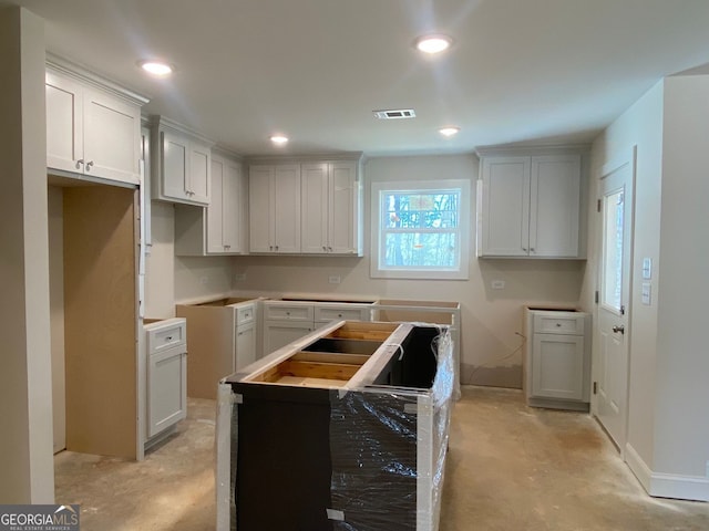 kitchen featuring recessed lighting, visible vents, unfinished concrete flooring, and a center island