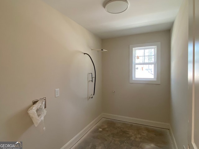 laundry room featuring baseboards