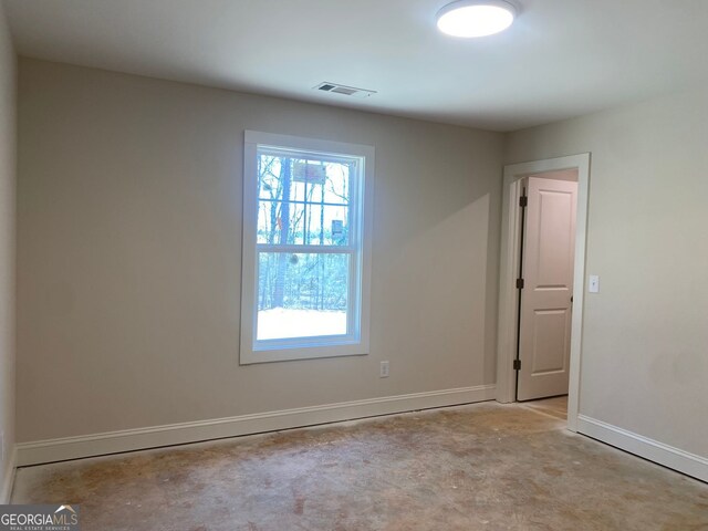 spare room featuring visible vents and baseboards