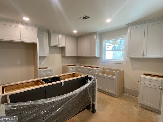 kitchen with visible vents, recessed lighting, and concrete floors