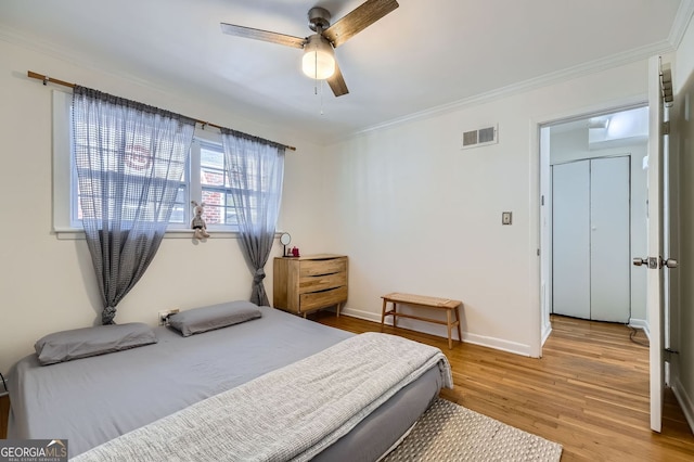 1284 Piedmont Ave NE Unit 12, Atlanta, GA 30309 - bedroom with light wood-style flooring, crown molding, a ceiling fan, and baseboards