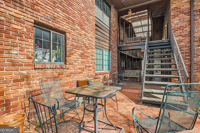 view of patio with stairway and outdoor dining space