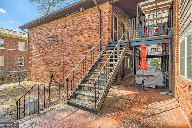 exterior space with stairway, brick siding, and crawl space