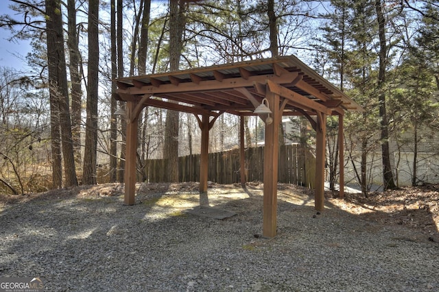 view of yard with a carport and fence