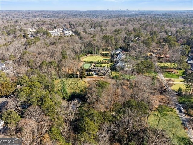 birds eye view of property with a forest view