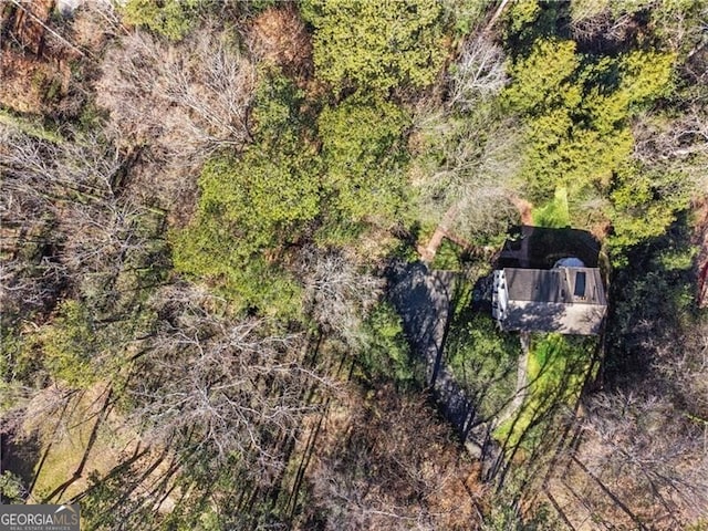 birds eye view of property with a forest view