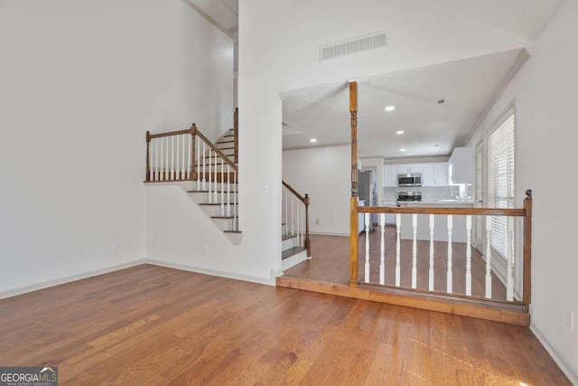 interior space with visible vents, baseboards, stairway, recessed lighting, and light wood-style flooring