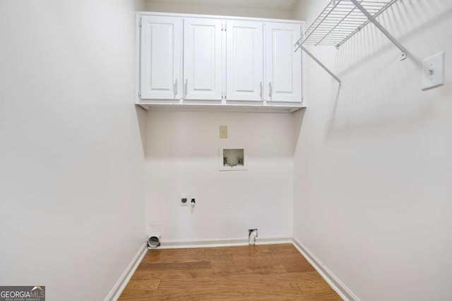 laundry room with light wood finished floors, cabinet space, hookup for an electric dryer, and washer hookup