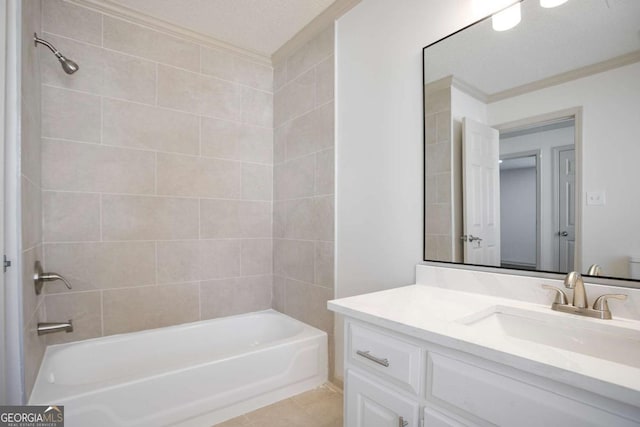 bathroom with a textured ceiling, bathtub / shower combination, vanity, and tile patterned flooring